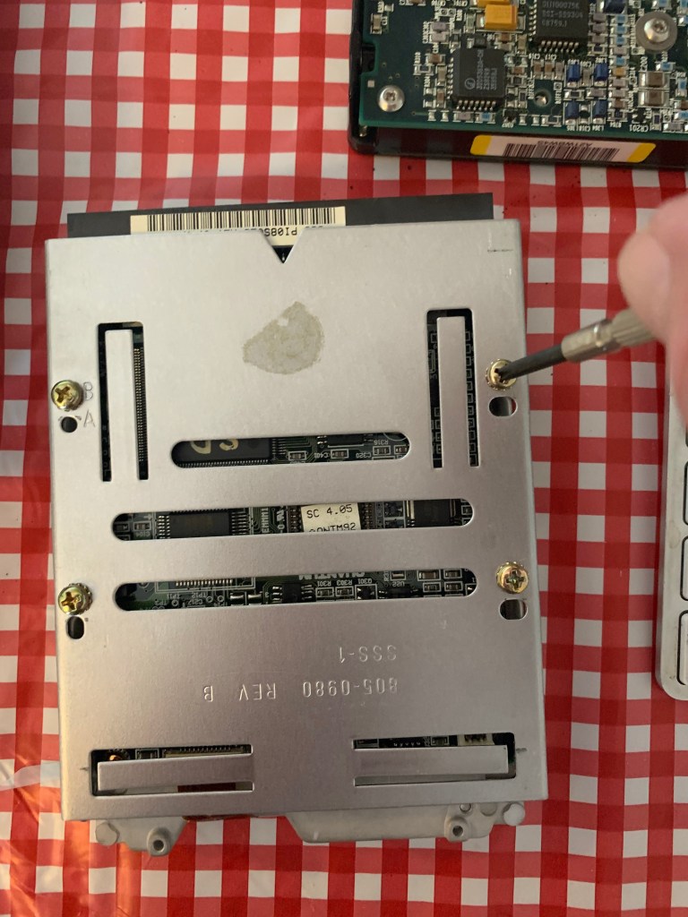 hard drive with mounting bracket and screwdriver