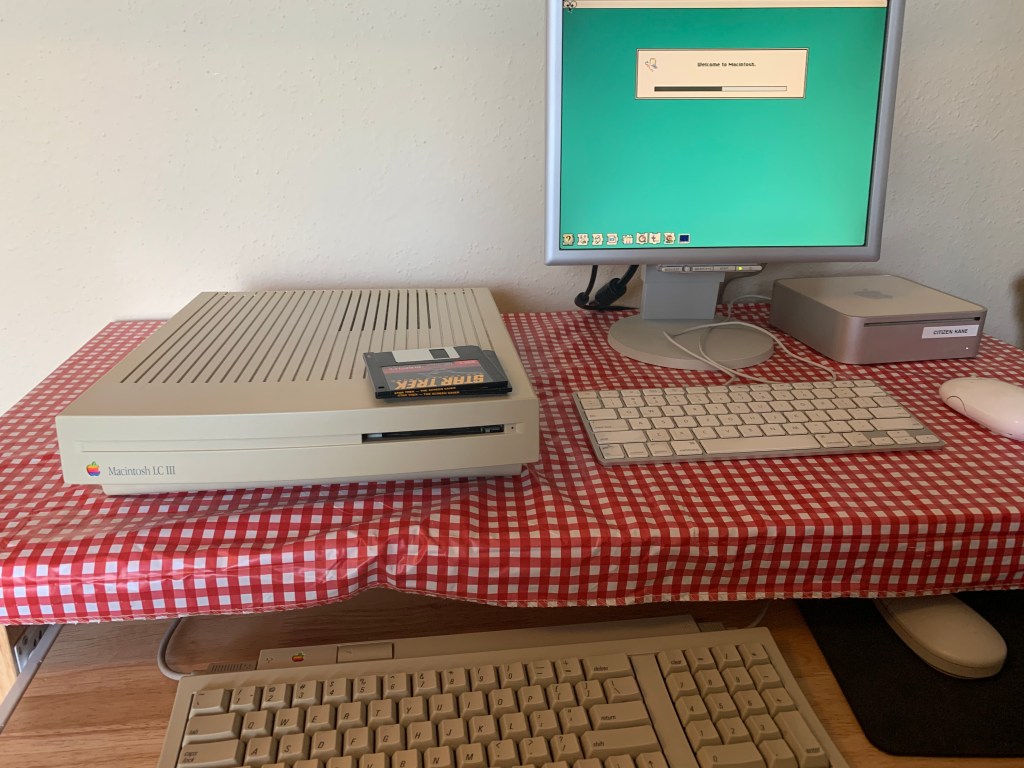 computers and monitor with Welcome to Macintosh message