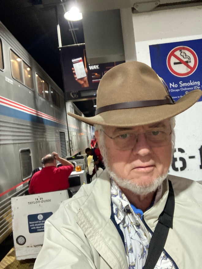Baggage cart at trainside in underground railyard.